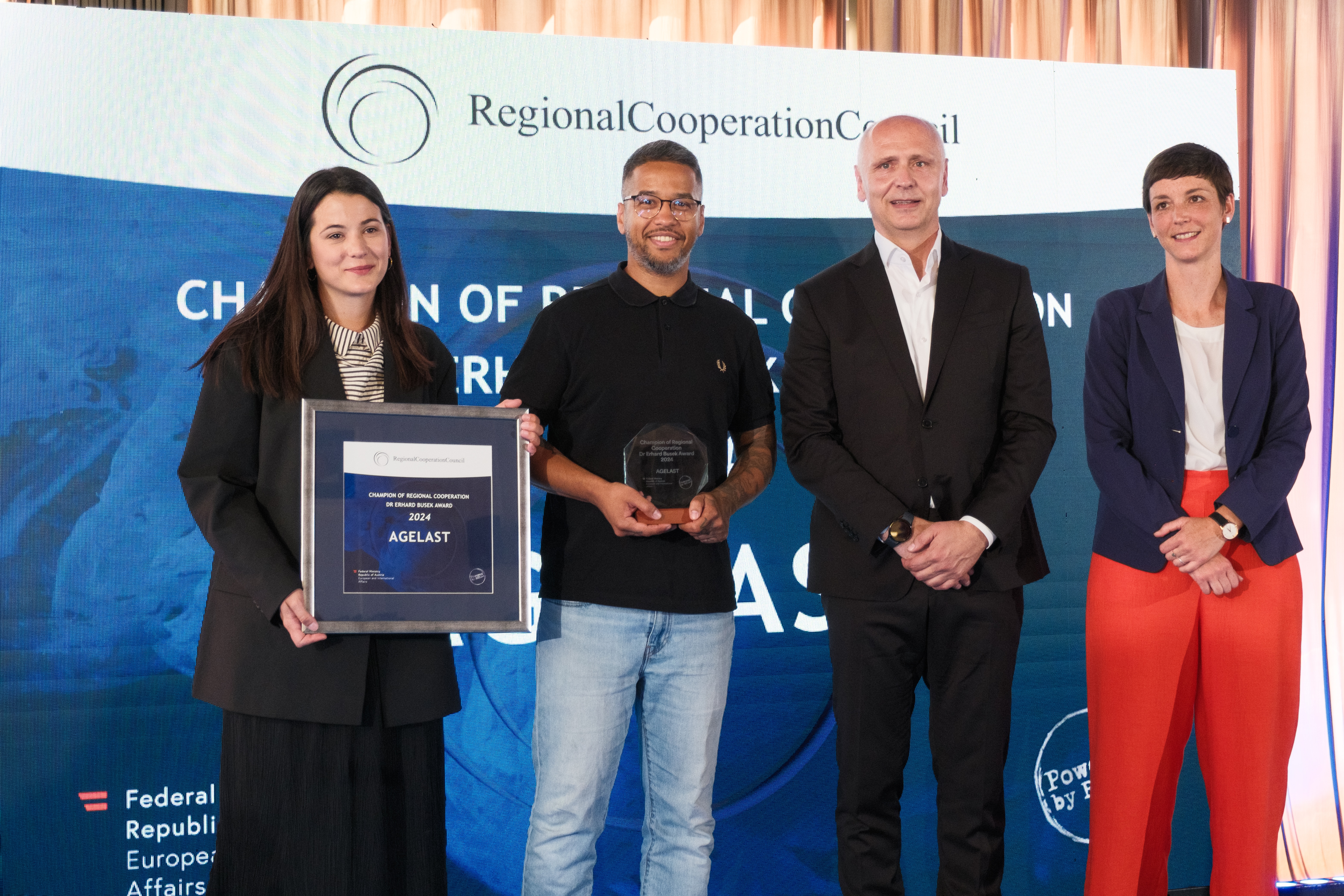 RCC Secretary General Amer Kapetanovic and Austrian Ambassador to Albania, Monika Zach with winners of Champion of Regional Cooperation Dr Erhard Busek Award for year 2024 - Agelast podcast - at the ceremony held in Tirana on 15 June 2025 (Photo: RCC/Armand Habazaj)