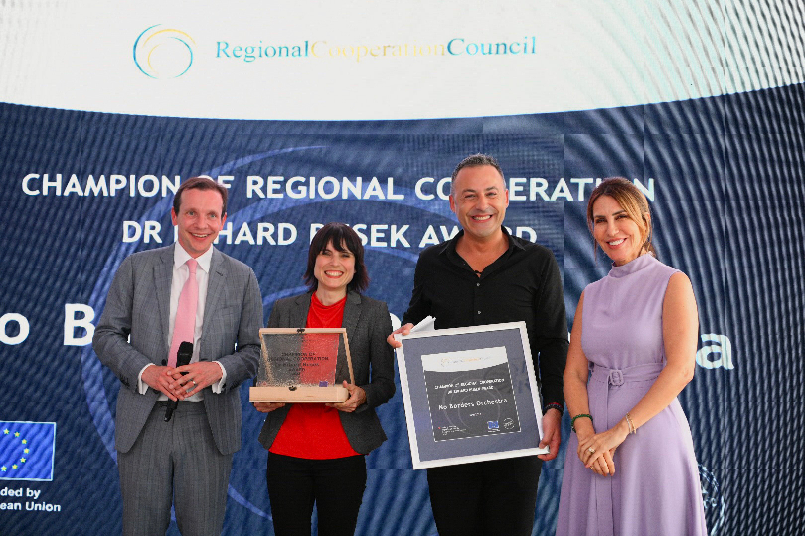 RCC Secretary General Majlinda Bregu and Deputy Director for General European Matters at Federal Ministry for European and International affairs Thomas Stoelezl with the Members of No Border Ocherstra at the Champion of Regional Cooperation dr. Erhard Busek ceremony in Budva on 05 June 2023 (Photo: Armand Habazaj)