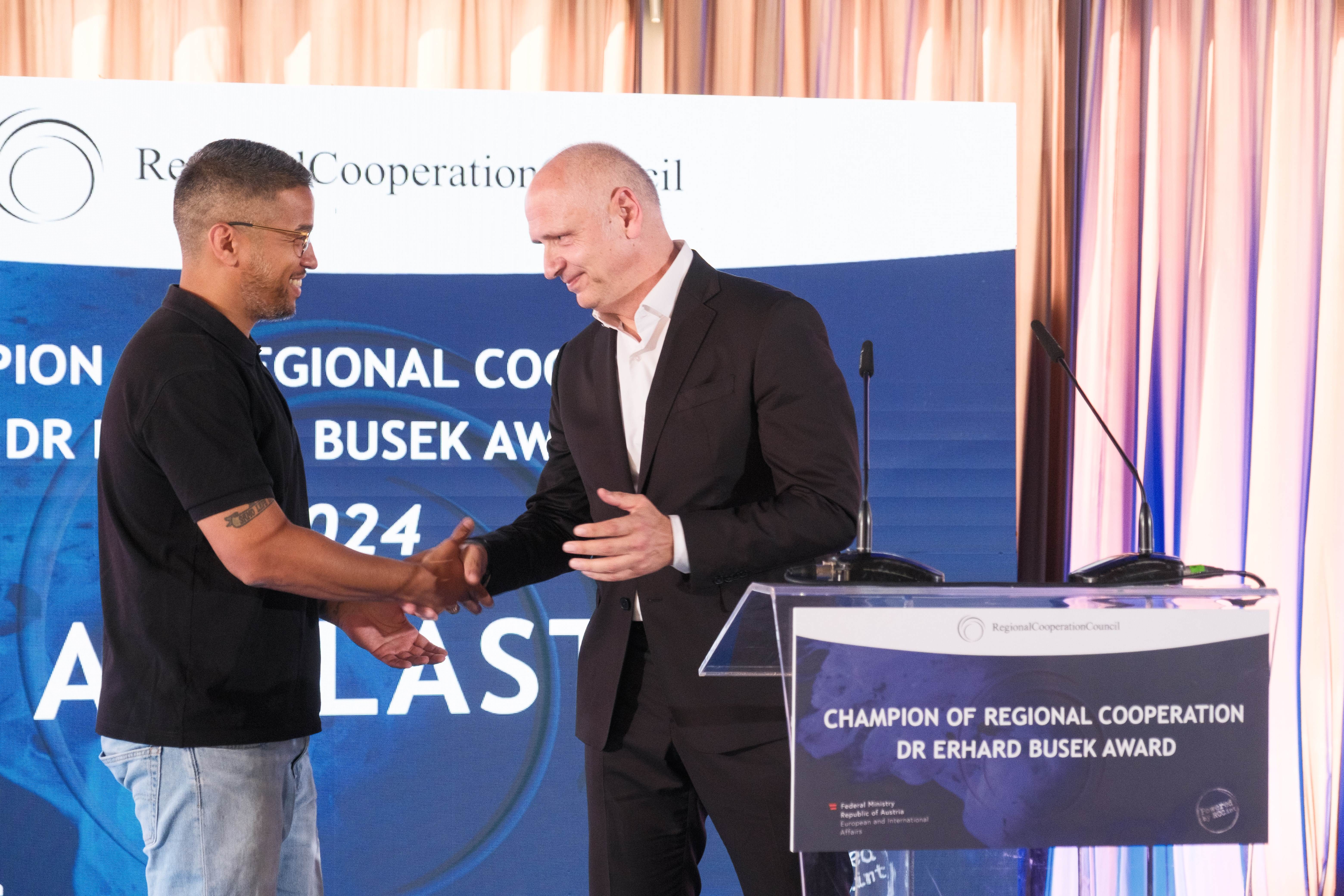RCC Secretary General Amer Kapetanovic with Galeb Nikacevic on behalf of the Agelast podcast, the winner of the Champion of Regional Cooperation Dr Erhard Busek Award for year 2024 at the ceremony held on 15 June 2025 in Tirana (Photo: RCC/Armand Habazaj)