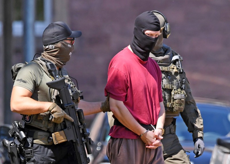 Photo: Police escort Stephan Ernst, suspected of killing Walter Lübcke, the administrative chief of the western city of Kassel, back to a helicopter after a hearing in Karlsruhe, southern Germany, on July 2. ULI DECK/AFP/Getty Images 