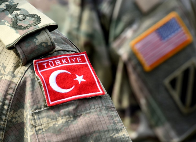 Photo: Turkish flag and US flag on army uniform. Turkish and US troops