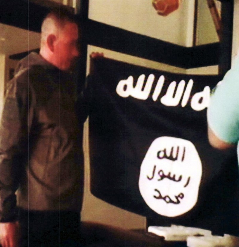  In this July 8, 2017 file image taken from FBI video and provided by the U.S. Attorney’s Office in Hawaii on July 13, 2017, Army Sgt. 1st Class Ikaika Kang holds an Islamic State group flag after allegedly pledging allegiance to the terror group at a house in Honolulu. Photo: FBI/U.S Attorney’s Office, District of Hawaii/AP/File
