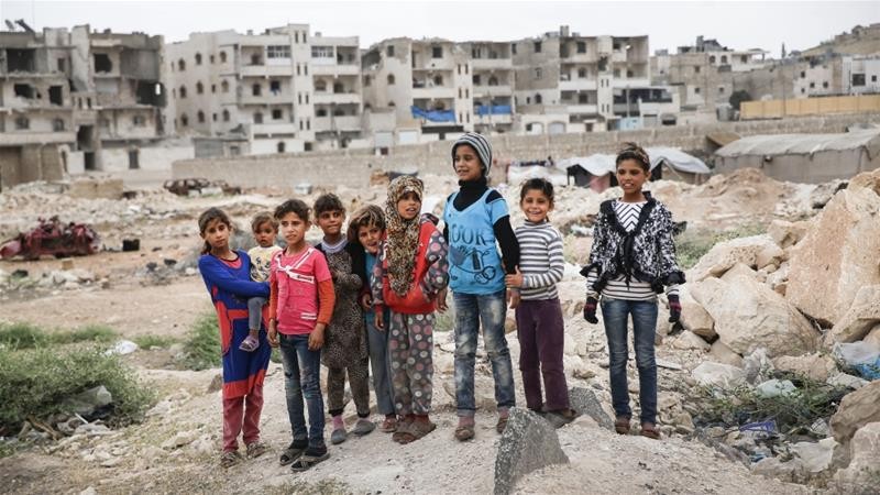 Photo: Children stand in the outskirts of al-Bab, northern Syria [Lefteris Pitarakis/AP Photo]