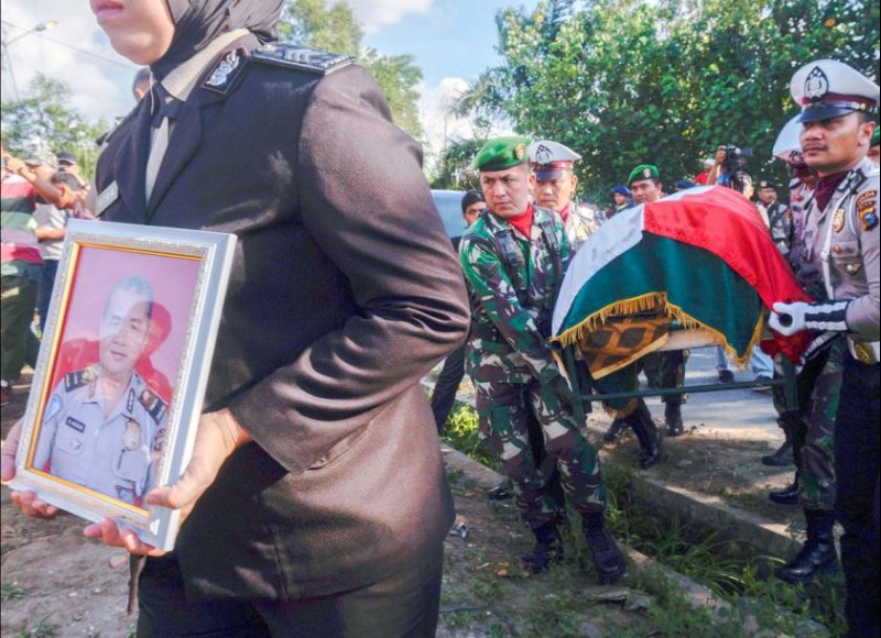 Indonesian police and military personnel carry the coffin of Auzar, a police officer who was killed during an attack on police headquarters in Pekanbaru, Riau province, Indonesia, on May 16. Photo - EPA