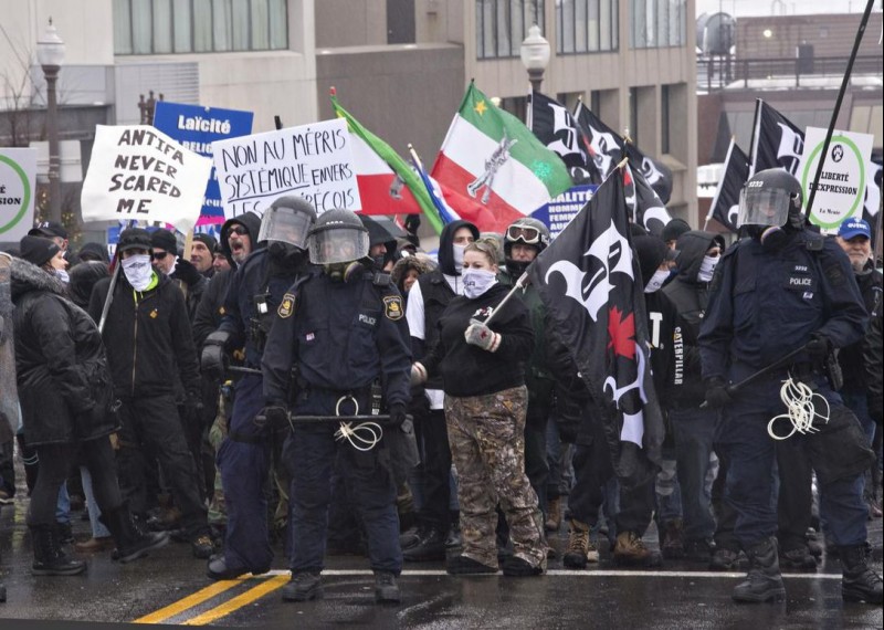 Storm Alliance demonstrators walk to the legislature during a demonstration where anti-facists and extreme right groups faced off in Quebec City last year.  (Jacques Boissinot / THE CANADIAN PRESS)