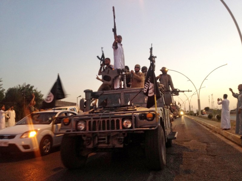 Photo: Fighters from the Islamic State group parade in a commandeered Iraqi security forces armored vehicle on the main road at the northern city of Mosul, Iraq, on June 23, 2014. (AP Photo, File)