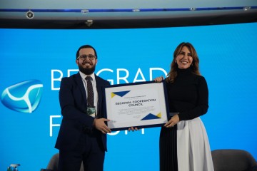 Majlinda Bregu, Secretary General of the Regional Cooperation Council (RCC)  receiving European Western Balkans award on behalf of the organization at the ceremony held in Belgrade on 26 October 2021. On photo with Nemanja Todorovic Stiplija, European Western Balkans Editor-in-Chief (Photo: RCC/Milos Miskov)